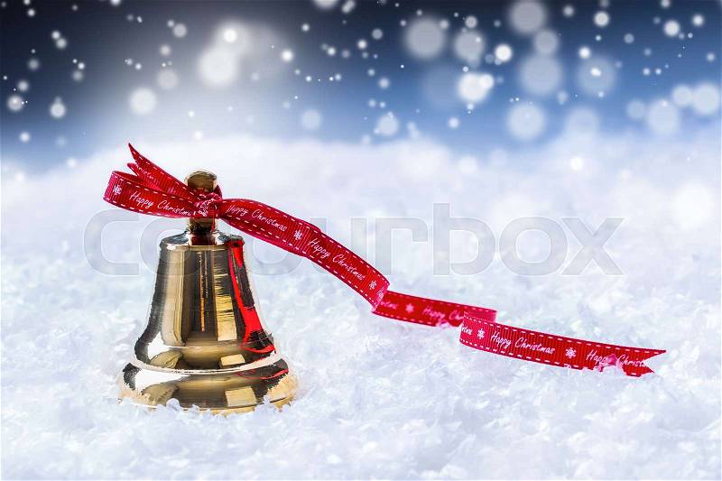 Christmas. Christmas bell with red ribbon and snowy background. Happy christmas text, stock photo