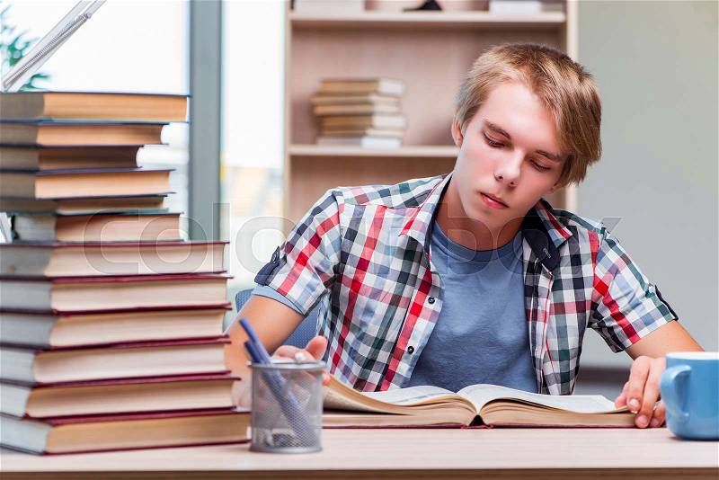 Young man student preparing for college exams, stock photo