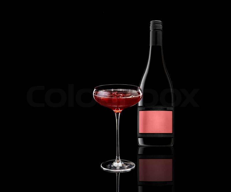 A glass of red wine and a bottle isolated on white, stock photo