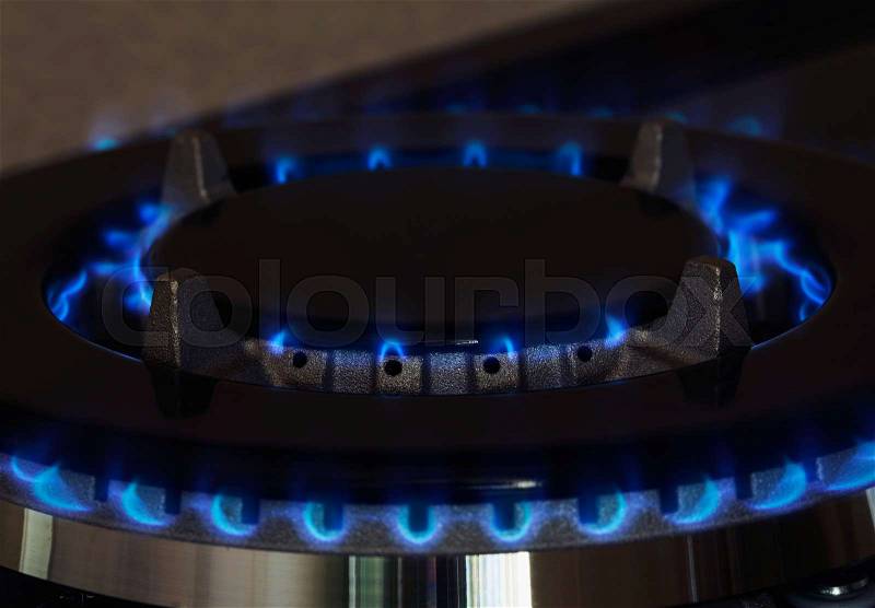 Gas burner is lit on the kitchen, stock photo