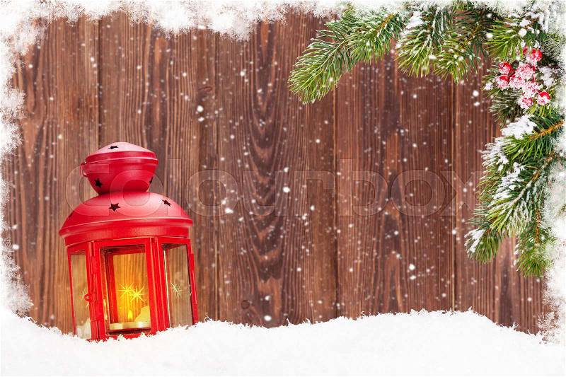 Christmas candle lantern and fir tree branch in snow. View with copy space, stock photo