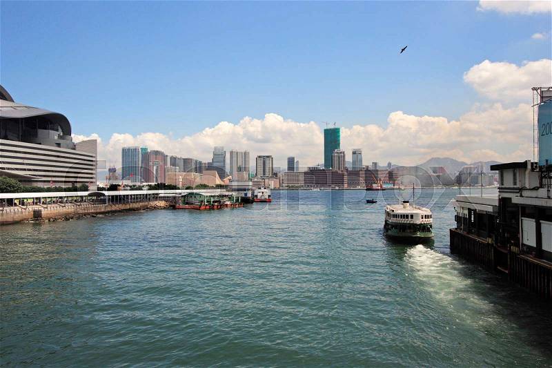 A ferry leaving Wan Chai ferry pier near Hong Kong Convention And Exhibition Centre, stock photo