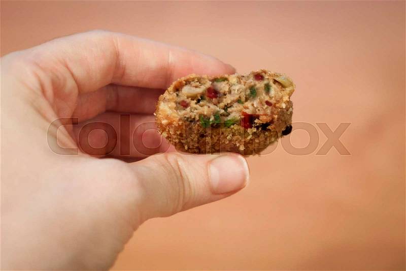 Meatball holding by hand, stock photo