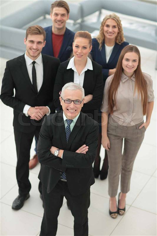 Smiling and confident business team standing in a conference room, stock photo