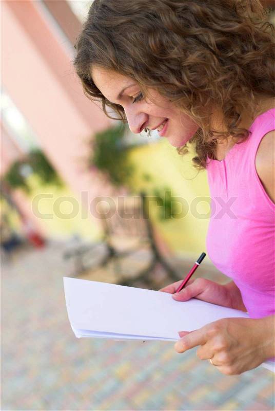 Businesswoman is preparing for annual report outdoors, stock photo