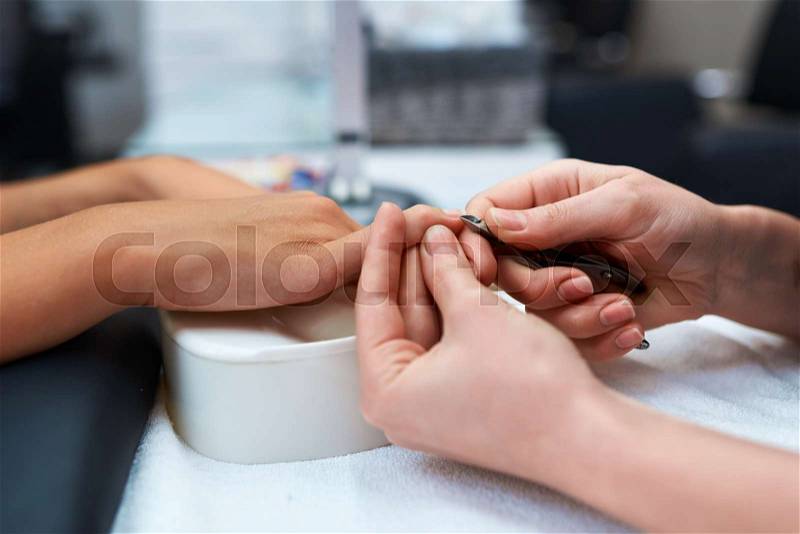 Manicure and hand the client, which are cut cuticle nippers, stock photo