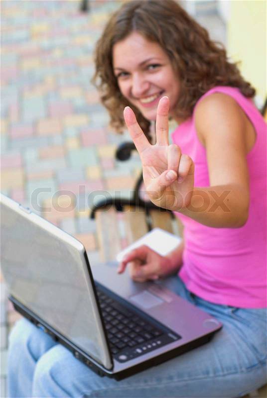 Young female student is showing victory sign, stock photo