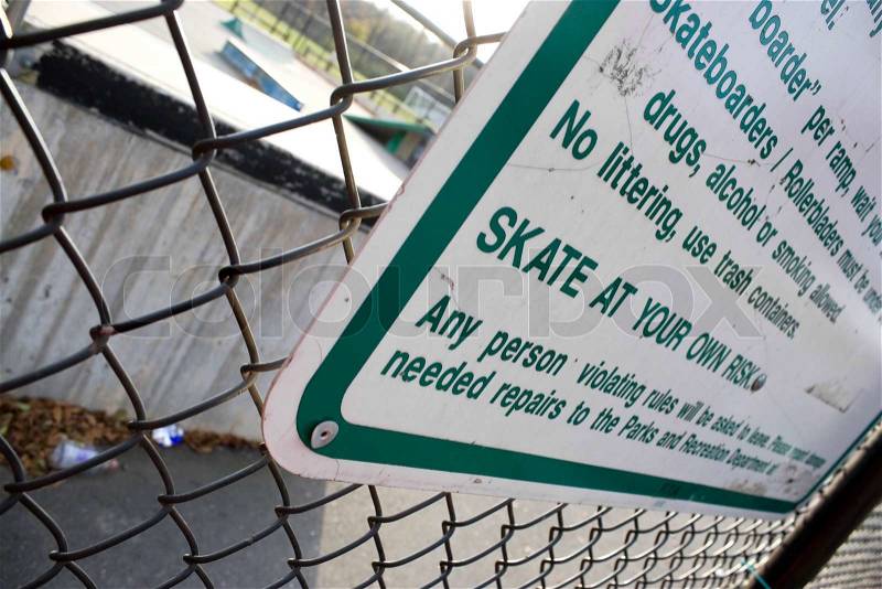 A sign at the skate park clearly states that you will skate at your own riskShallow depth of field, stock photo