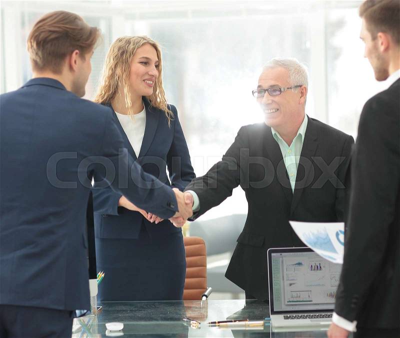 Mature businessman shaking hands to seal a deal with his partner, stock photo