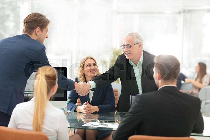 Mature businessman shaking hands to seal a deal with his partner, stock photo