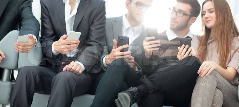 A group of young and happy young people using their phones and c, stock photo