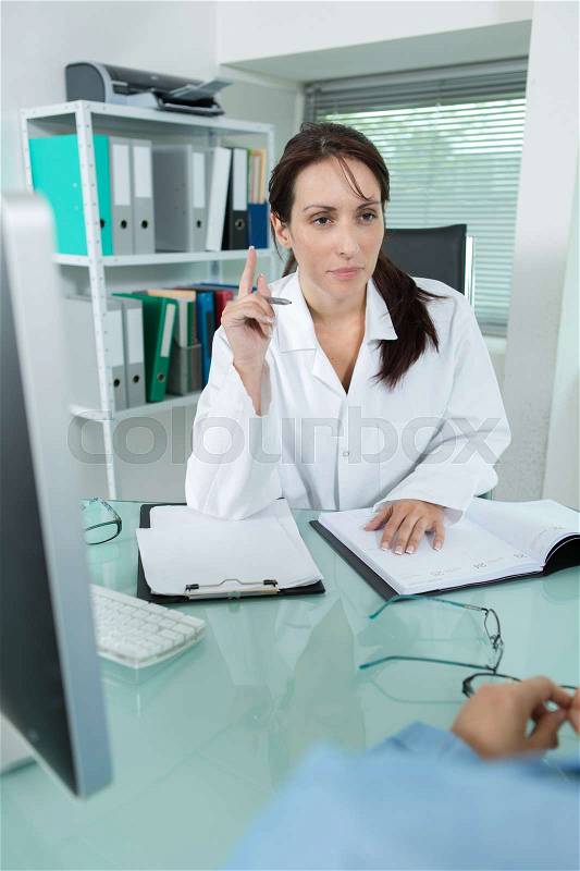 Doctor with pc computer giving results to a patient, stock photo