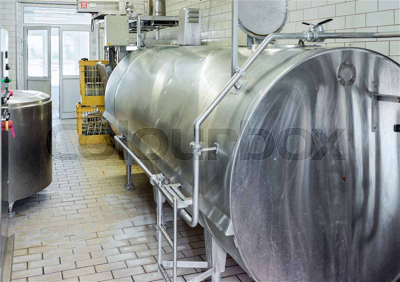 Liquid storage tank and pipe in the dairy for the production of Gruyere de Comte Cheese in Franche Comte, Burgundy, of France, stock photo