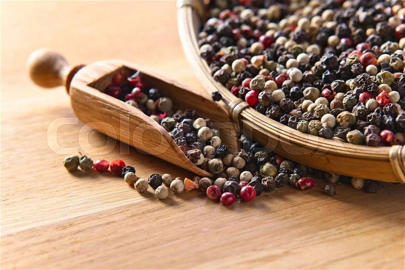 Black ,white and red peppercorns on wooden table, stock photo