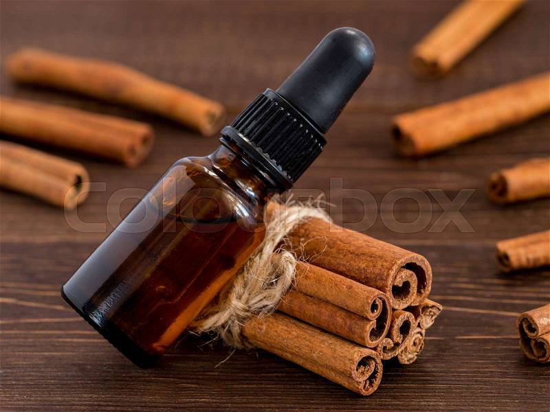 Cinnamon sticks and bottle with cinnamon essential oil, stock photo
