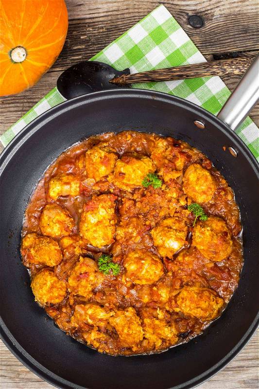 Chicken meatballs with vegetable spicy sauce in the pan. Studio Photo, stock photo