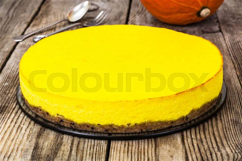 A popular dessert-homemade pumpkin cheesecake on wooden background.Studuo Photo, stock photo
