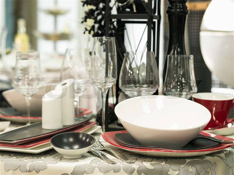Set of new dishes on table with tablecloth. Shallow DOF, stock photo