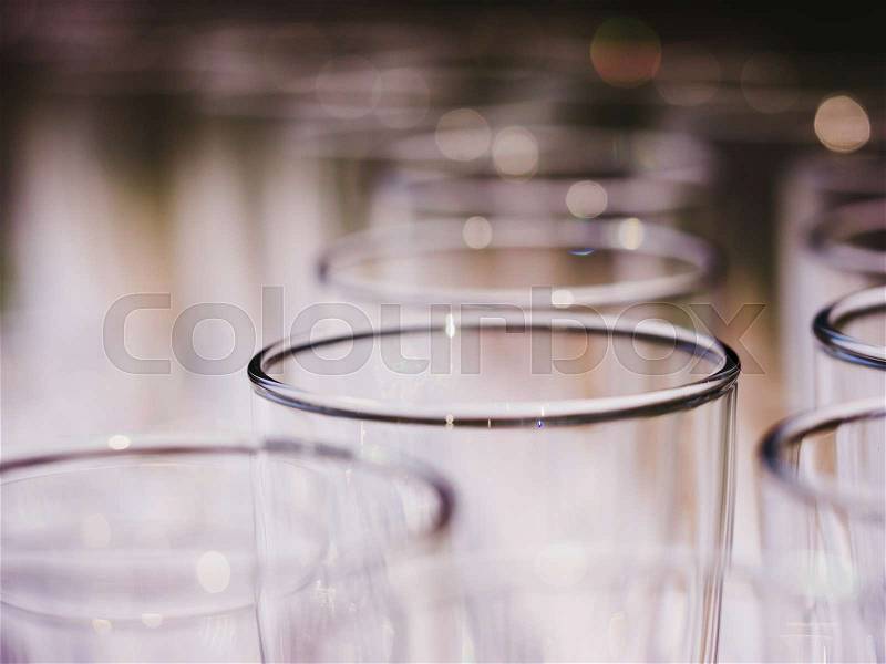 Row of glasses macro shot. Empty glasses on a banquet table close up, stock photo