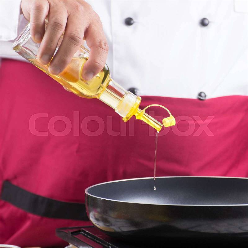 Chef pouring vegetable oil to the pan / cooking stir fry vegetarian noodle concept, stock photo