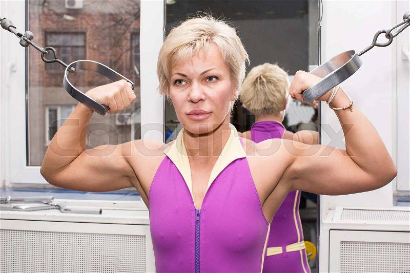 Adult female bodybuilding competitions in the gym, stock photo