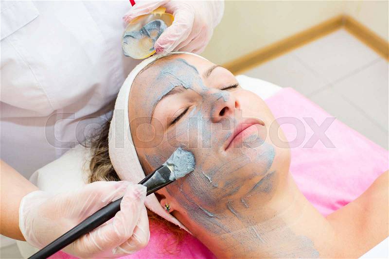 Process of massage and facials in beauty salon, stock photo