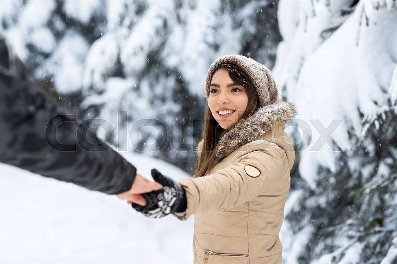 Young Romantic Couple Walking In Snow Forest Outdoor Asian Woman Hold Man Hand Follow Me Winter Pine Woods, stock photo