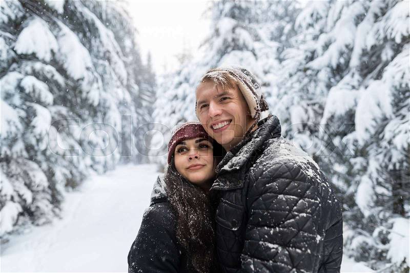 Young Romantic Couple In Snow Forest Outdoor Man And Woman Embrace Winter Pine Woods, stock photo