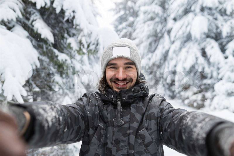 Young Man Smile Camera Taking Selfie Photo In Winter Snow Forest Guy Outdoors Walking White Park, stock photo