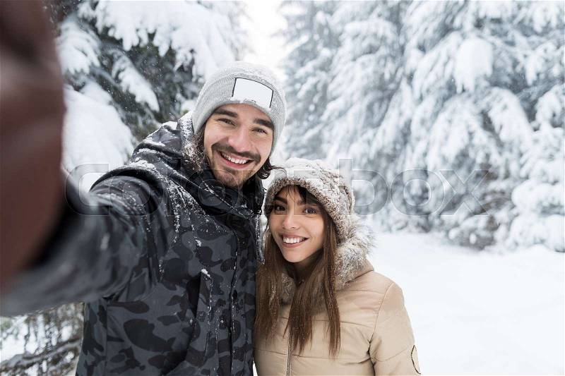 Man Taking Selfie Photo Young Romantic Couple Smile Snow Forest Outdoor Winter Pine Woods, stock photo