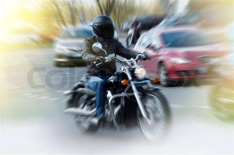Fast moving biker on motorcycle with blur background, stock photo