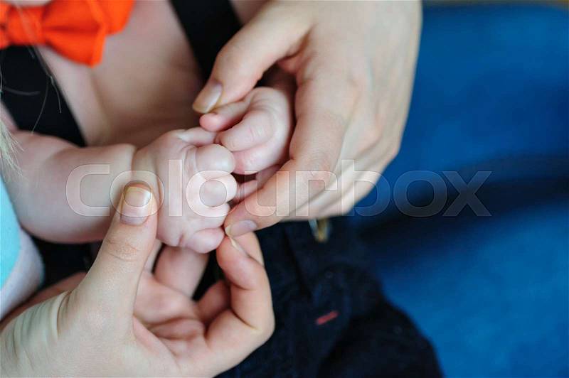 Mom keeps hands son in her arms, stock photo