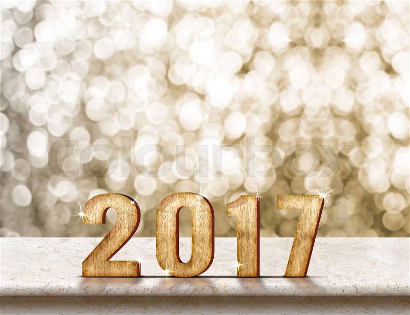 Happy New Year 2017 wood texture on marble table with sparkling gold bokeh wall,Holiday concept, stock photo