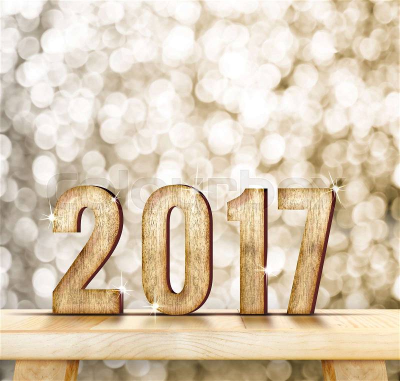 2017 year wood number on wood table with gold sparkling bokeh wall and wooden plank floor,leave space for adding your content, stock photo