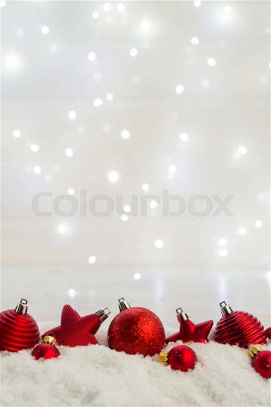 Christmas scene with snow - row of red balls with bokeh lights in background, stock photo