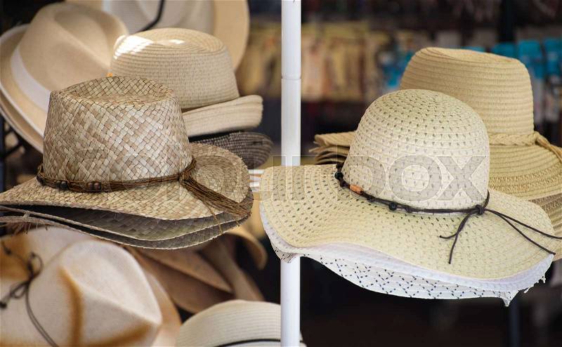 Straw hats for sale in the market, stock photo