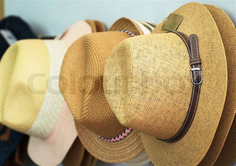 Straw hats for sale in the market, stock photo