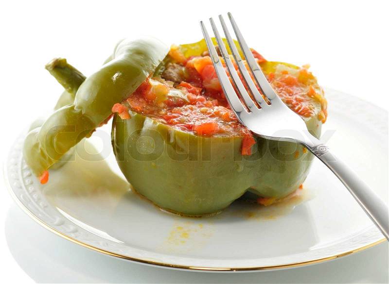 Stuffed green pepper on a plate with fork, stock photo