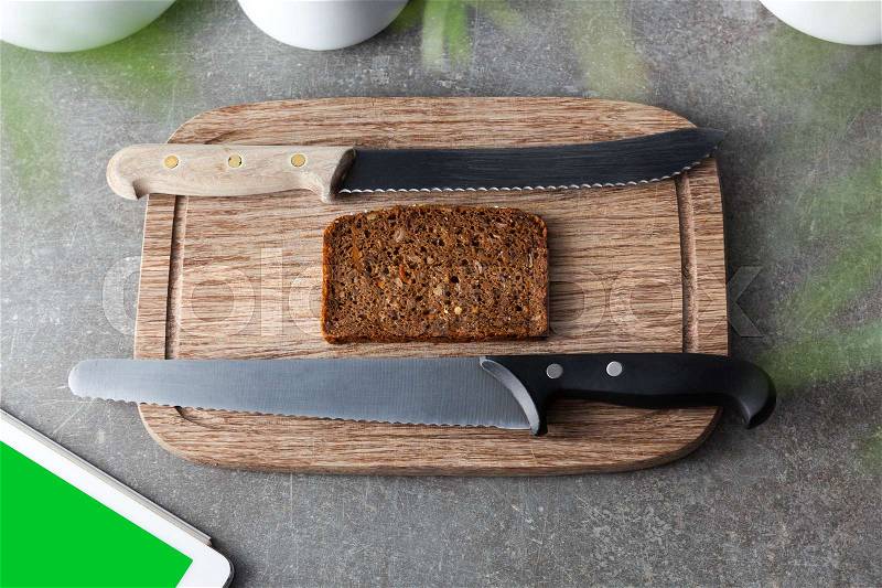 Ry bread breakfast on a cutting board with the ipad as entertainment, stock photo