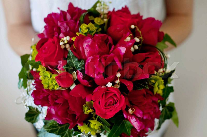 Fresh bridal bouquet. Deep red summer flowers, roses, peonies, lilies of the valley, stock photo