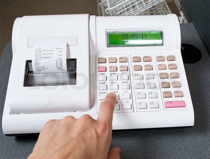 Hand and cash register, stock photo