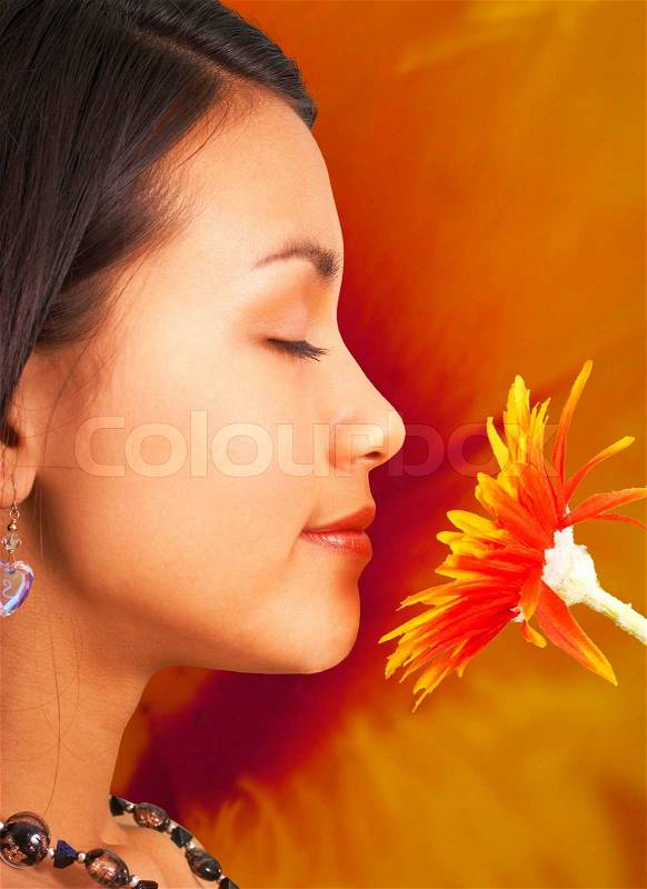 Relaxed Girl At Peace Smelling A Flower, stock photo