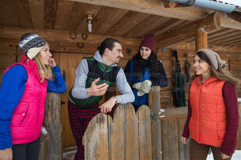 People Group Wooden Country House Winter Snow Mountain Resort Cottage Friends Talking On Vacation, stock photo
