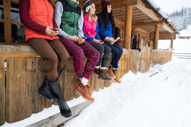 People Group Using Smart Phone Messaging Internet Wooden Country House Winter Snow Mountain Resort Cottage Friends On Vacation, stock photo