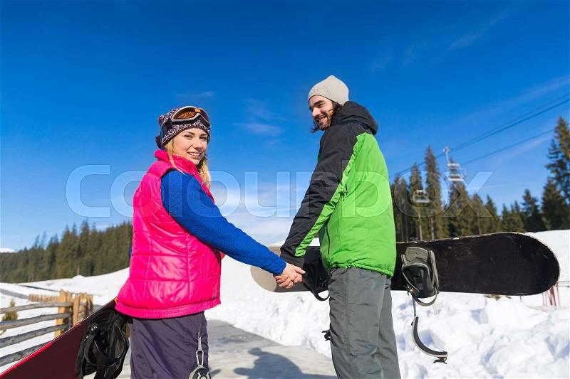 Couple With Snowboard And Ski Resort Snow Winter Mountain Smiling Man And Woman Extreme Sport Vacation, stock photo