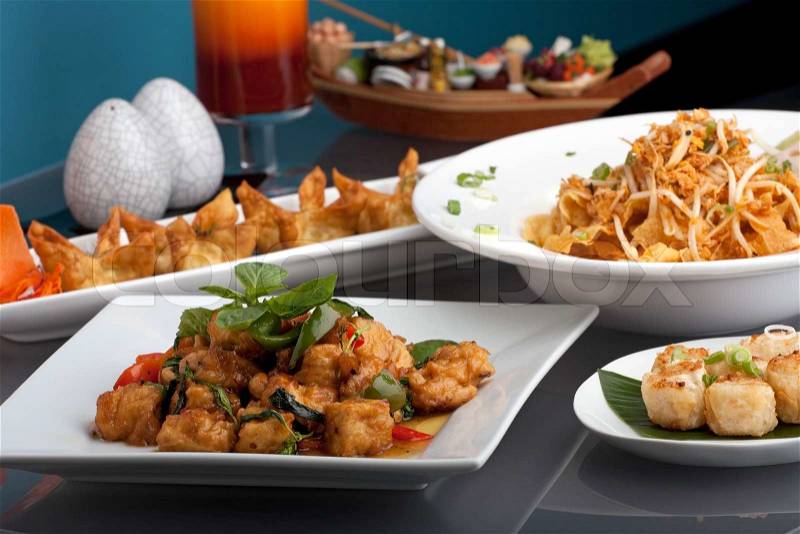 A big assortment of Thai foods and appetizers presented beautifully with fancy garnish, stock photo