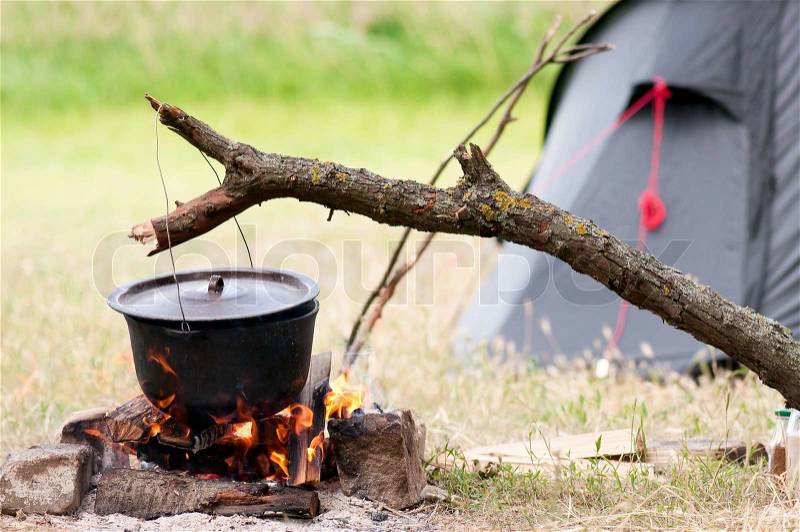 Camping kitchenware - pot on the fire at an outdoor campsite, stock photo