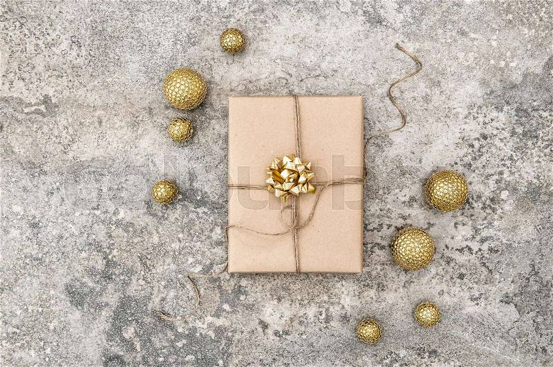 Wrapped gift and christmas decoration on concrete stone background, stock photo