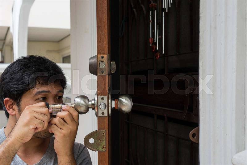 Locksmith open the home door by his tools and his job technic - can use to display or montage on product, stock photo