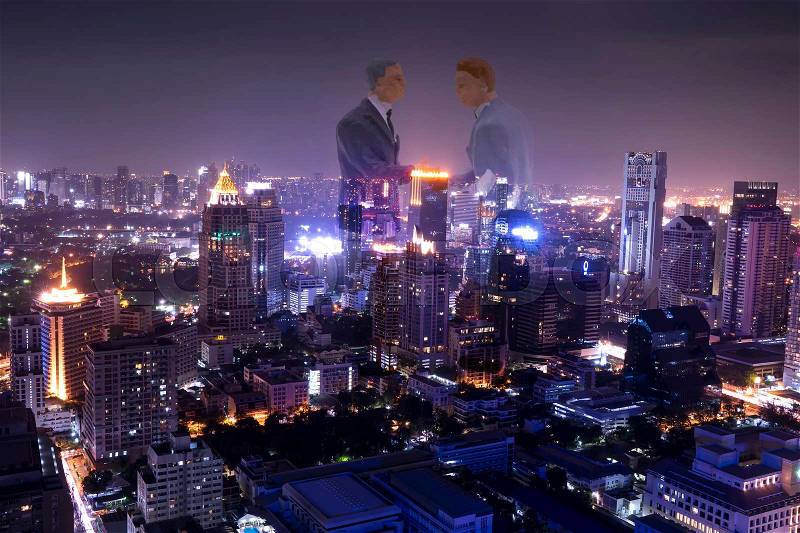 Double exposure of mini businessman make agreement and night urban cityscape - can use to display or montage on products, stock photo